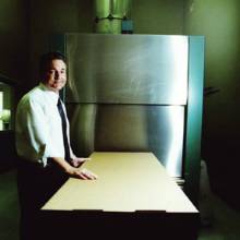 Mortuary professional Bill Gabriel displays one of the cardboard boxes used during cremation at his look-in crematorium in El Mirage. Cremation accounts for more than half of all dispositions in Arizona. phm0412 du1 md