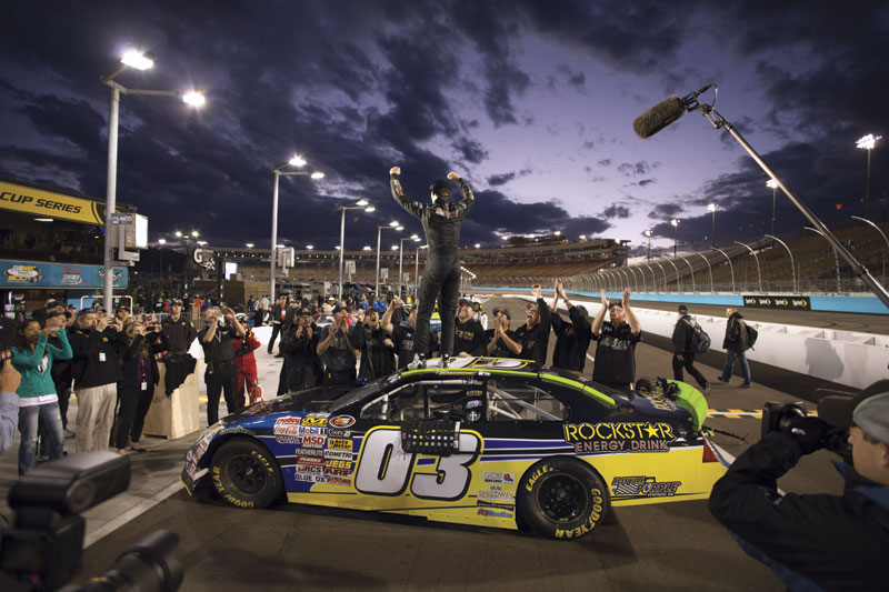 Dylan Kwasniewski exults with his race crew after winning the Talking Stick Resort 50, part of a developmental series for younger drivers.