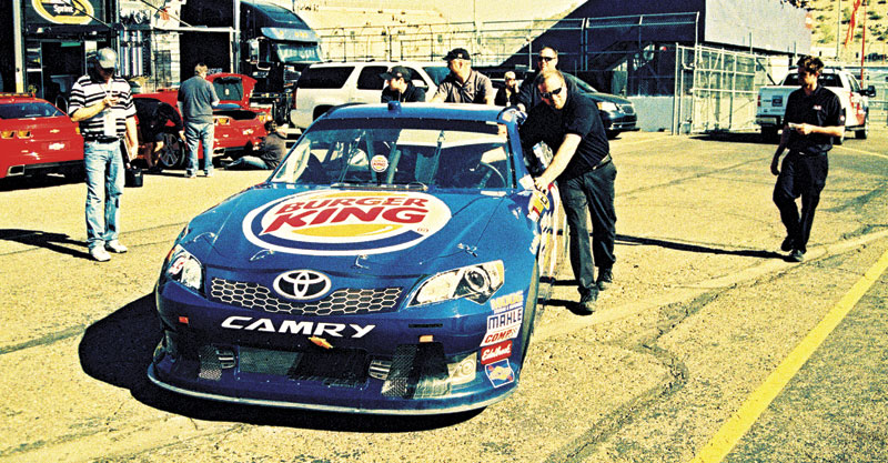 Spring Cup driver Travis Kvapil rolls out of the garage area at PIR.