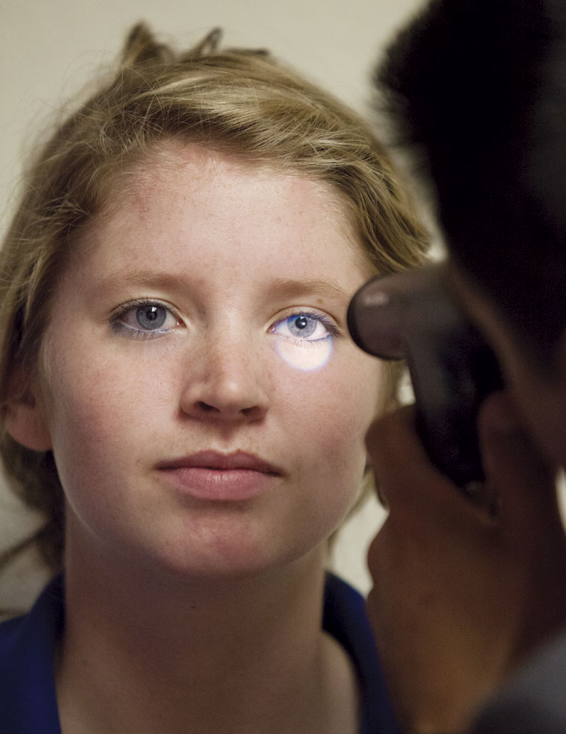 Dr. Cardenas conducts an eye test on Xavier College Preparatory student Madison Barasha, who sustained two head injuries while playing basketball. She quit that sport and now plays lacrosse, which is safer thanks to the use of protective head gear.
