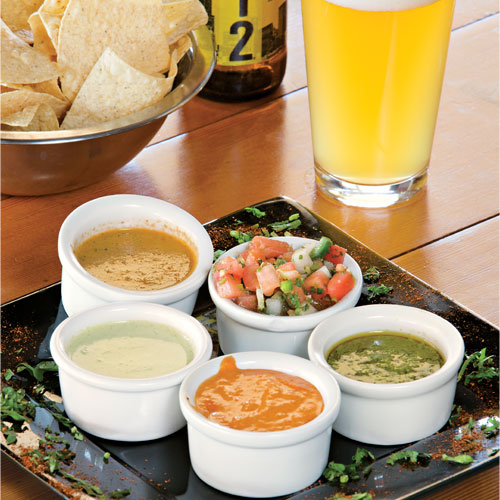 flight of five salsas with chips and Goose Island Urban Wheat beer