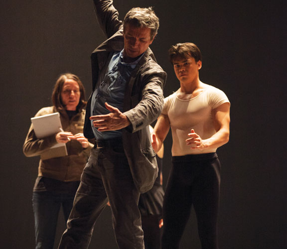 Ib Andersen demonstrates how to refine a movement during rehearsals.