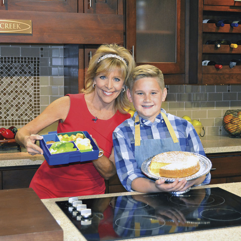 Cody holding his orange olive oil cake with Jan D&rsquo;Atri when he appeared on Arizona Midday on Channel 12.