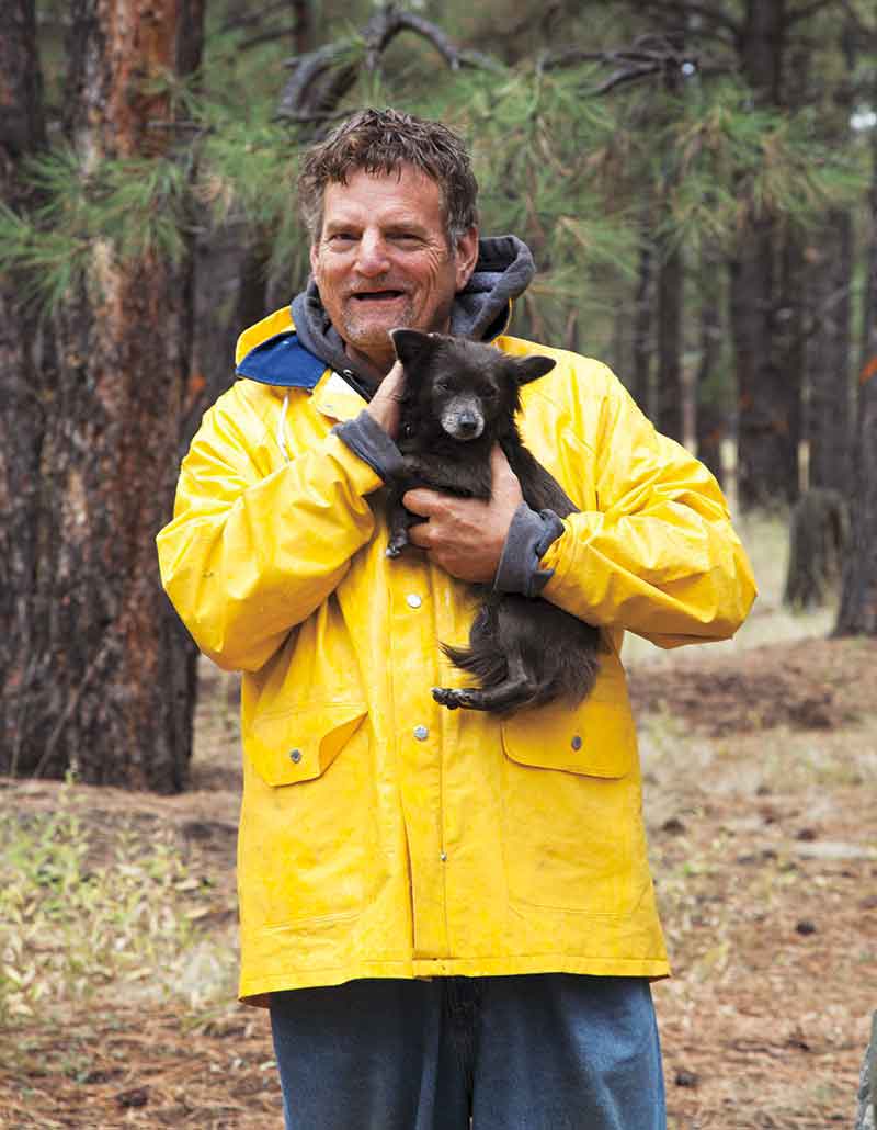 photo by Brenna Zumbro; An unidentified man living out of his truck in the forests near Flagstaff, with his dog Pepper.