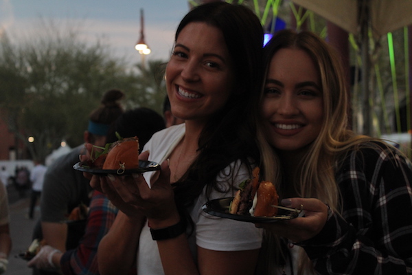 Zinburger employees proudly showcasing their Blissful Brie Burger. 