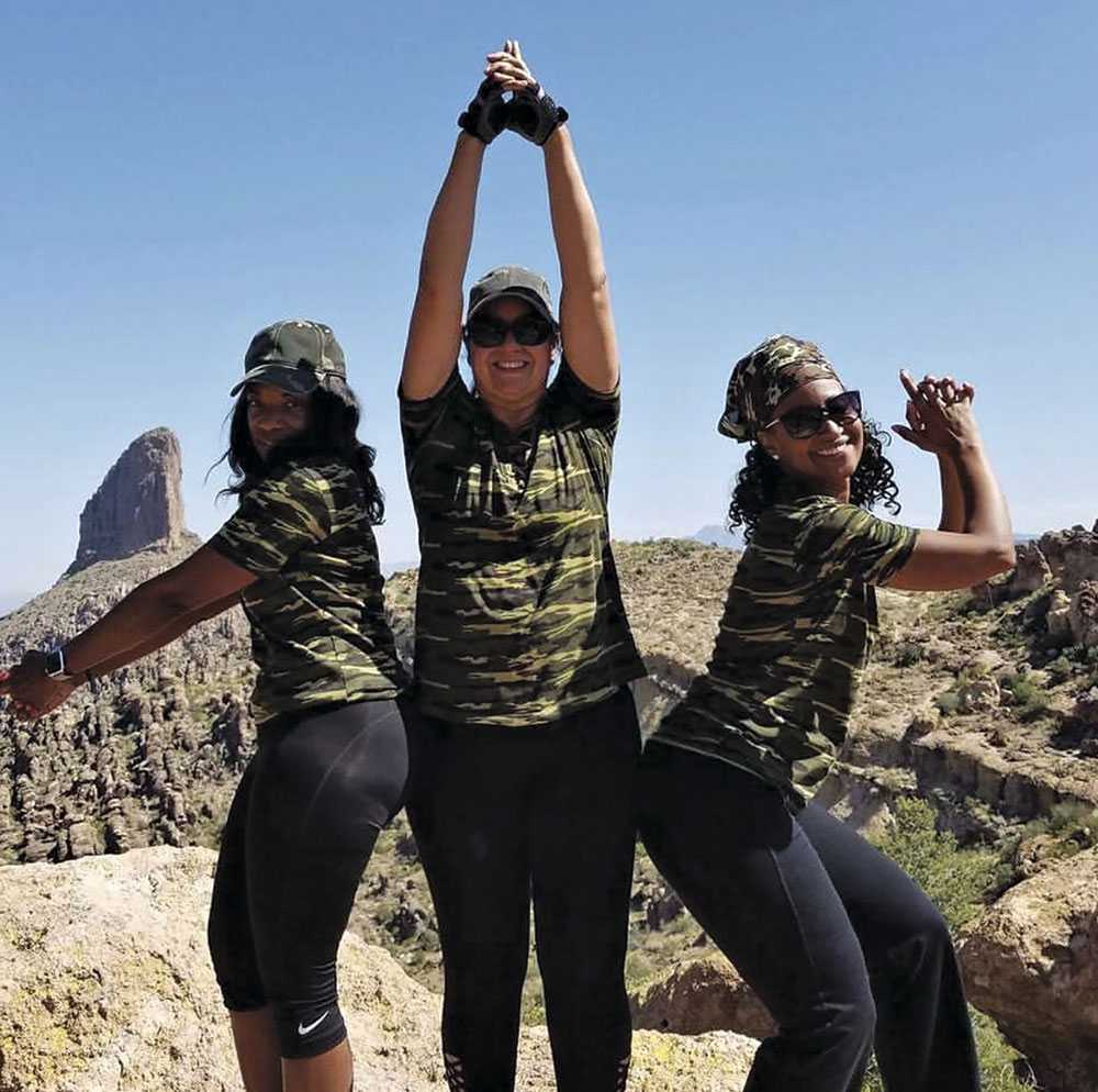 Gray (far left) and friends strike a #HikingAngel pose