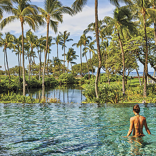 swimming in Mauna Lani’s adults-only pool; Photo courtesy Auberge Resorts