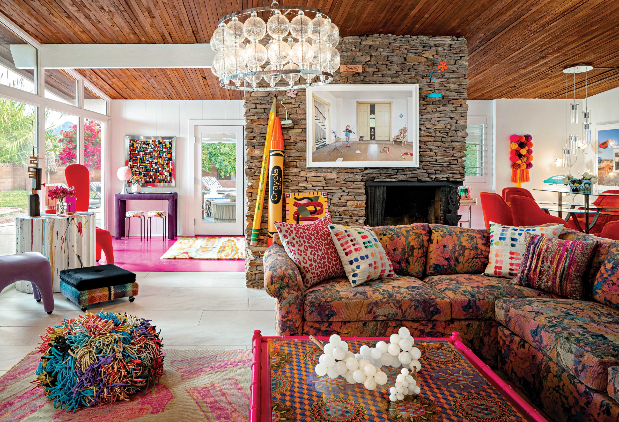 In the living room of interior designer Julia Buckingham’s historic Scottsdale home, quirky vintage finds and neon hues contrast and complement the abode’s original midcentury architecture. “We’re obsessed with the wooden slat ceiling, which we heard was sourced from California by the builders of the home in 1963,” she notes. In the living room of interior designer Julia Buckingham’s historic Scottsdale home, quirky vintage finds and neon hues contrast and complement the abode’s original midcentury architecture. “We’re obsessed with the wooden slat ceiling, which we heard was sourced from California by the builders of the home in 1963,” she notes.