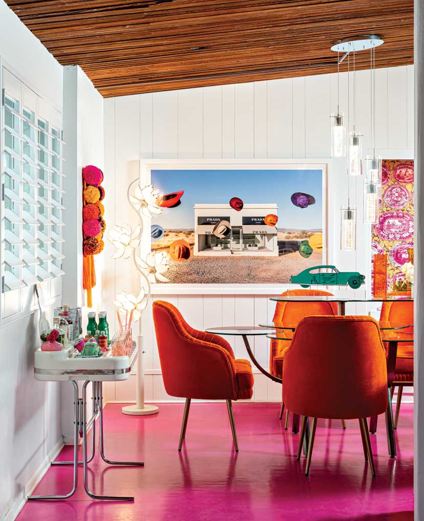 A vintage table created by Design Institute of America in the 1980s anchors the dining room, while shocking pink lacquered floors, pop art and original 1970s “Oryk” bar add fantastical elements to the space. A vintage table created by Design Institute of America in the 1980s anchors the dining room, while shocking pink lacquered floors, pop art and original 1970s “Oryk” bar add fantastical elements to the space.