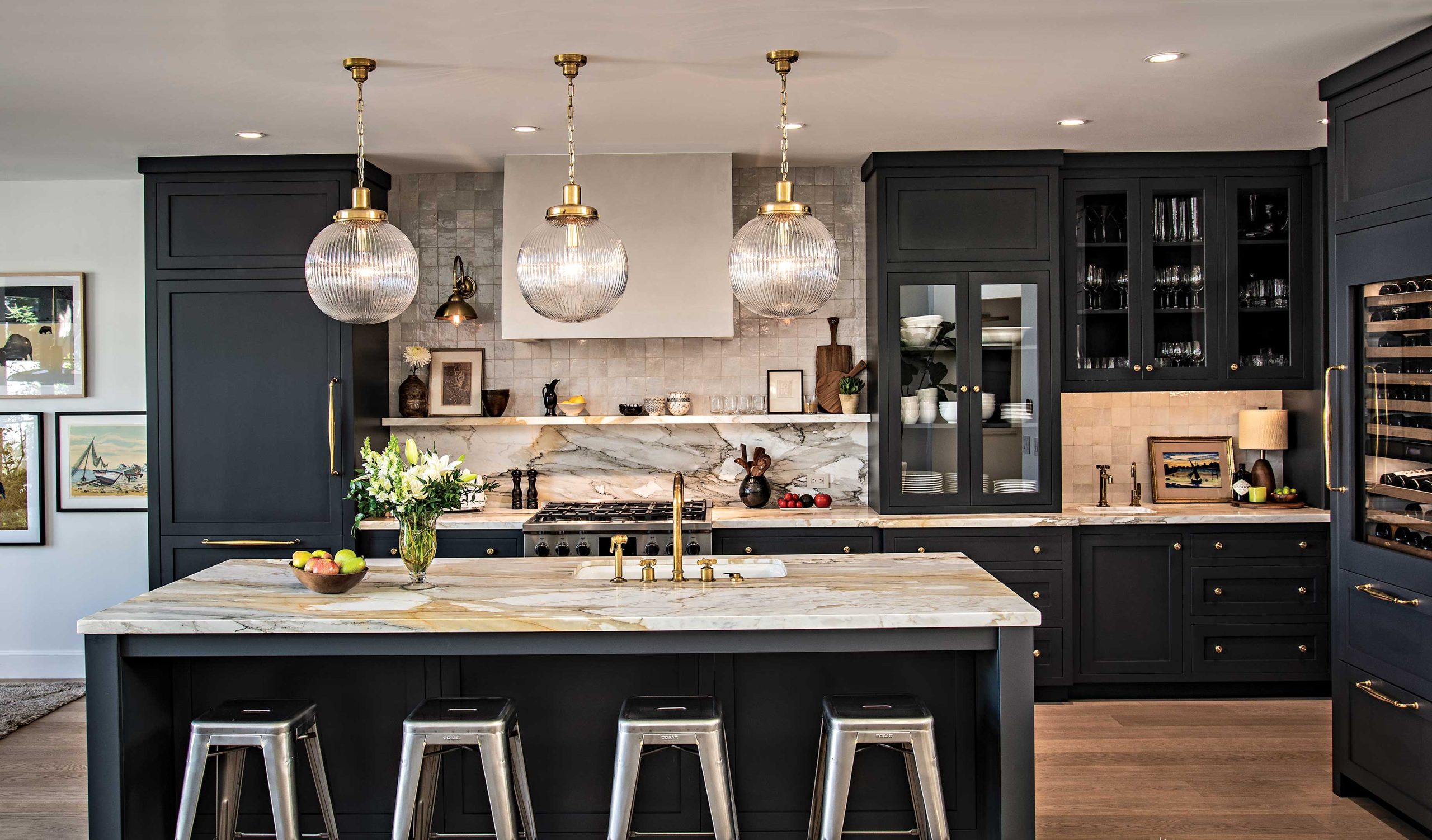 The kitchen’s deep blue cabinetry is a dramatic counterpoint to the rest of the interior’s pale tones. Brass fixtures add a polished note. The kitchen’s deep blue cabinetry is a dramatic counterpoint to the rest of the interior’s pale tones. Brass fixtures add a polished note.