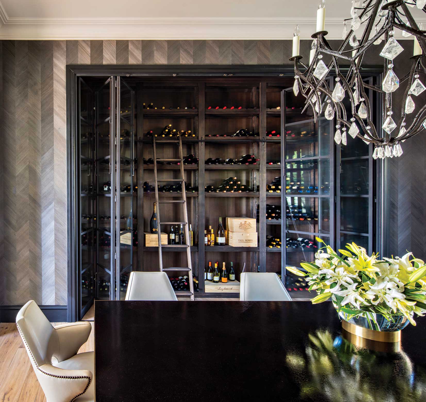 A wine “library,” complete with a ladder for hard-to-reach vintages, is tucked into a dining enclave. Folding glass doors open the room up for browsing, uncorking and admiring. A wine “library,” complete with a ladder for hard-to-reach vintages, is tucked into a dining enclave. Folding glass doors open the room up for browsing, uncorking and admiring.