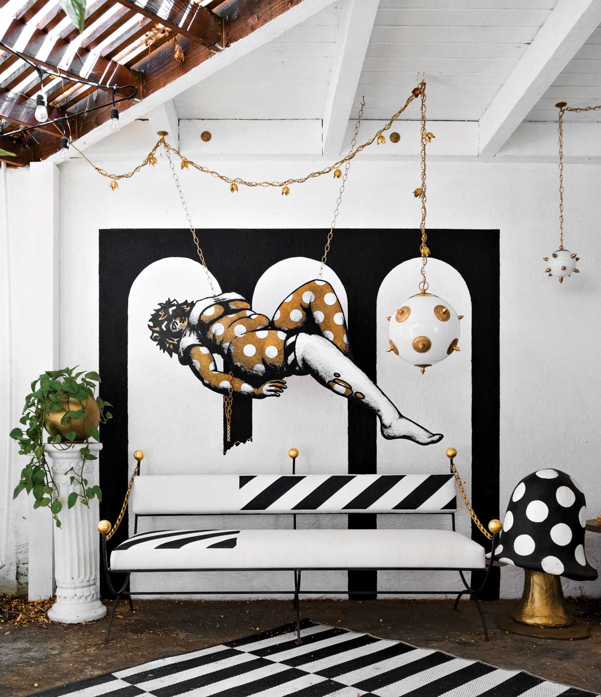 A covered patio area at McDermott’s home shows off a handful of his creations, including a pair of Neoclassical Mace lamps, a hand-patinated hanging brass sculpture inspired by Japanese comics and a sofa he designed and crafted. A covered patio area at McDermott’s home shows off a handful of his creations, including a pair of Neoclassical Mace lamps, a hand-patinated hanging brass sculpture inspired by Japanese comics and a sofa he designed and crafted.