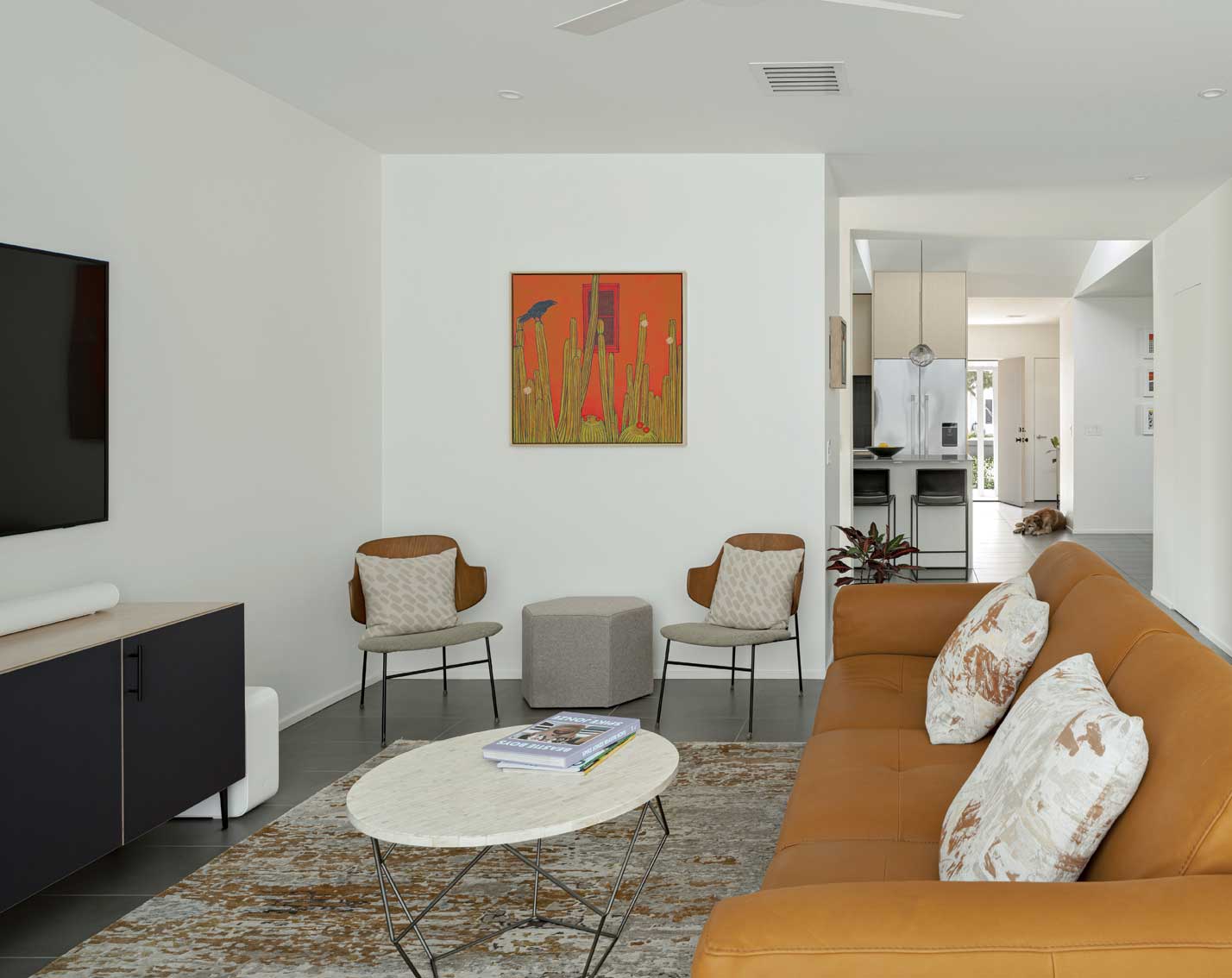 A pair of original Penguin lounge chairs by Ib Kofod-Larsen add form to the home’s living room addition.