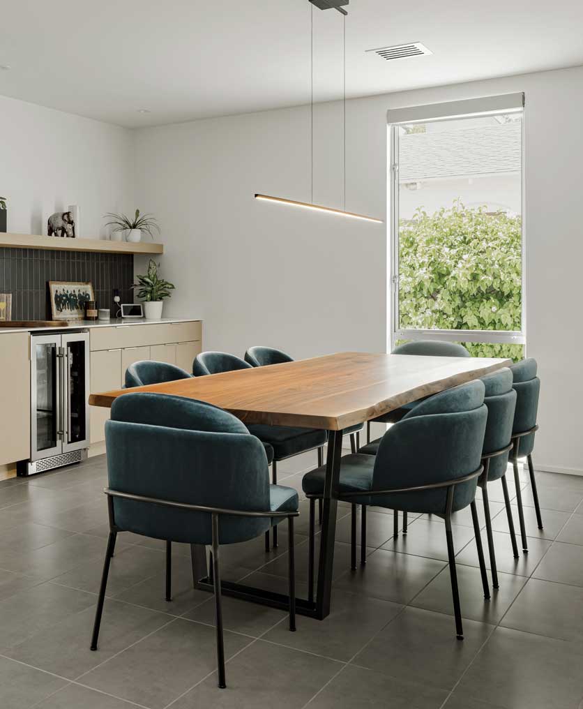 The original primary bedroom was opened up to create the new dining room, where a large window adds light. 