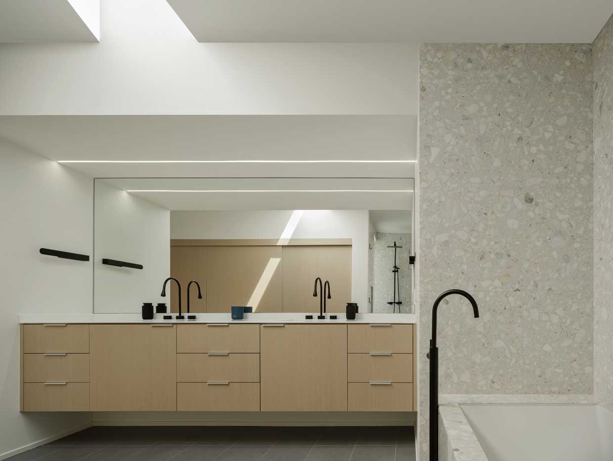 The primary bathroom, with its floating vanity and skylight, was part of the new addition. 