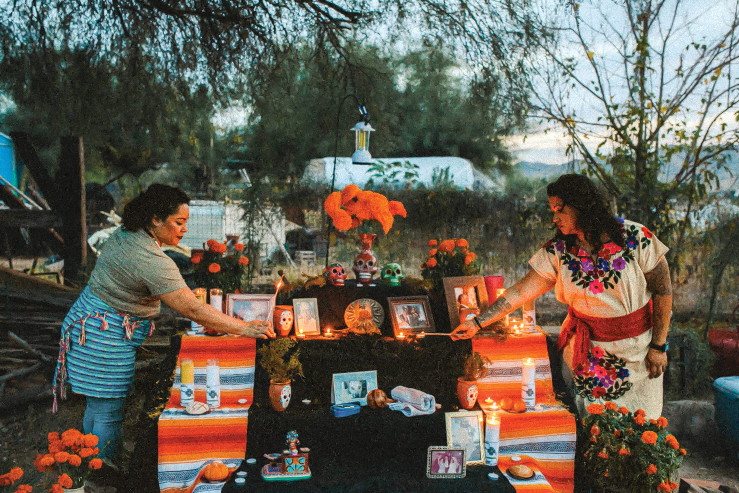 Enjolie Lafaurie (left)and Maria Del Carmen Parra Cano (right) perform a ceremony on Día de los Muertos, a time to honor loved ones who have passed. Photo by Perla Farias