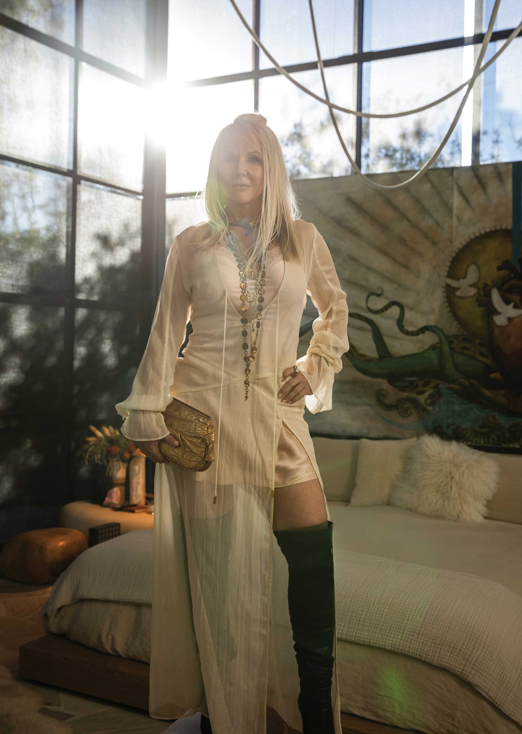 At her Scottsdale home, Lang wears: Chloé necklace; 1930s Egyptian souvenir necklace fom Vintage by Misty; Amayalili necklace; Chloé boots; vintage camisole from A Current Affair; Michael Costello for Revolve Dress; vintage Kooba bag