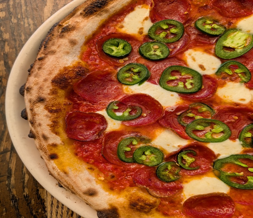 Craft 64’s Honey Bee Pizza, which features pepperoni, jalapeño and wildflower honey | Photo courtesy James Swann Craft 64’s Honey Bee Pizza, which features pepperoni, jalapeño and wildflower honey | Photo courtesy James Swann
