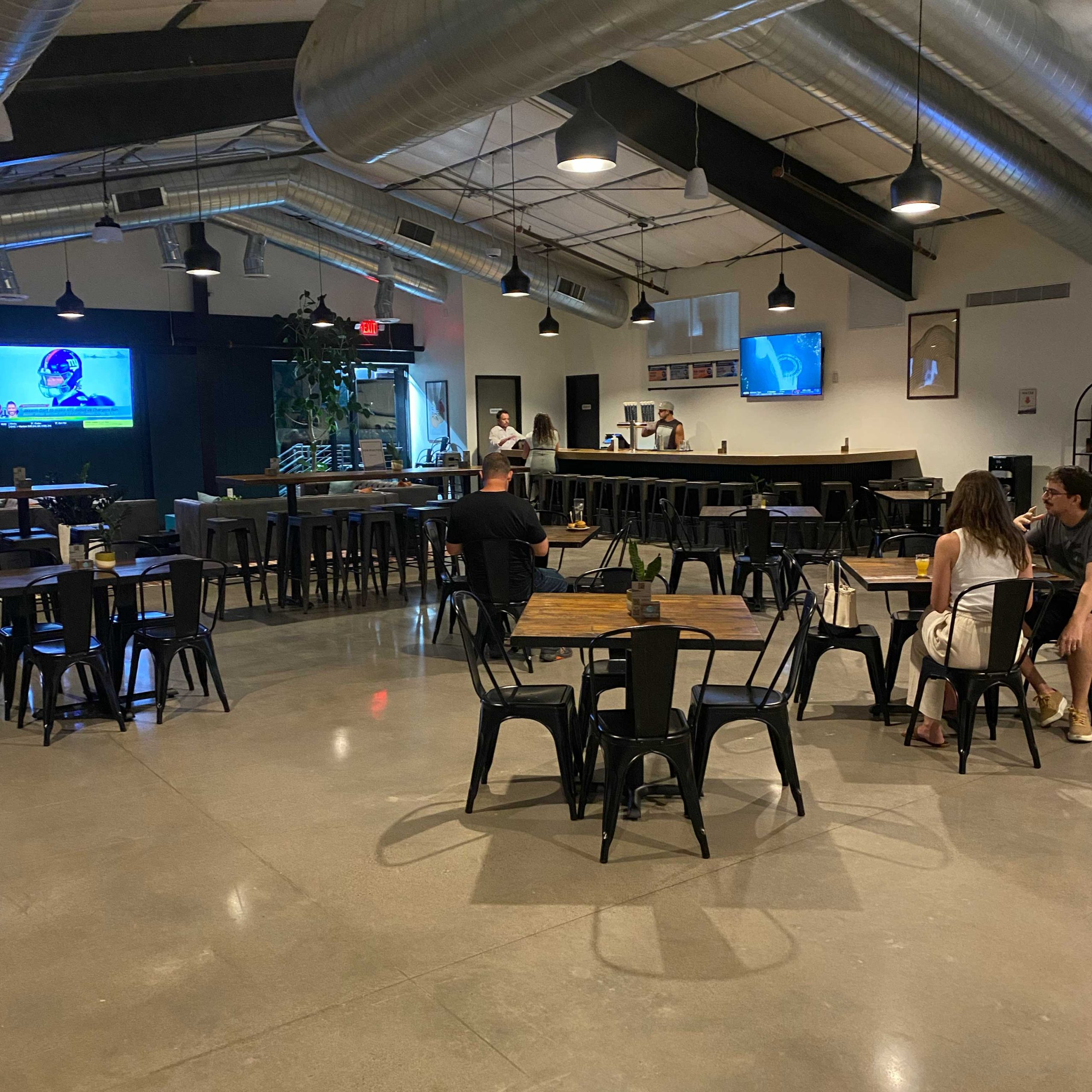 Upstairs area with bar, hightop seating, sectional sofas and big-screen TVs