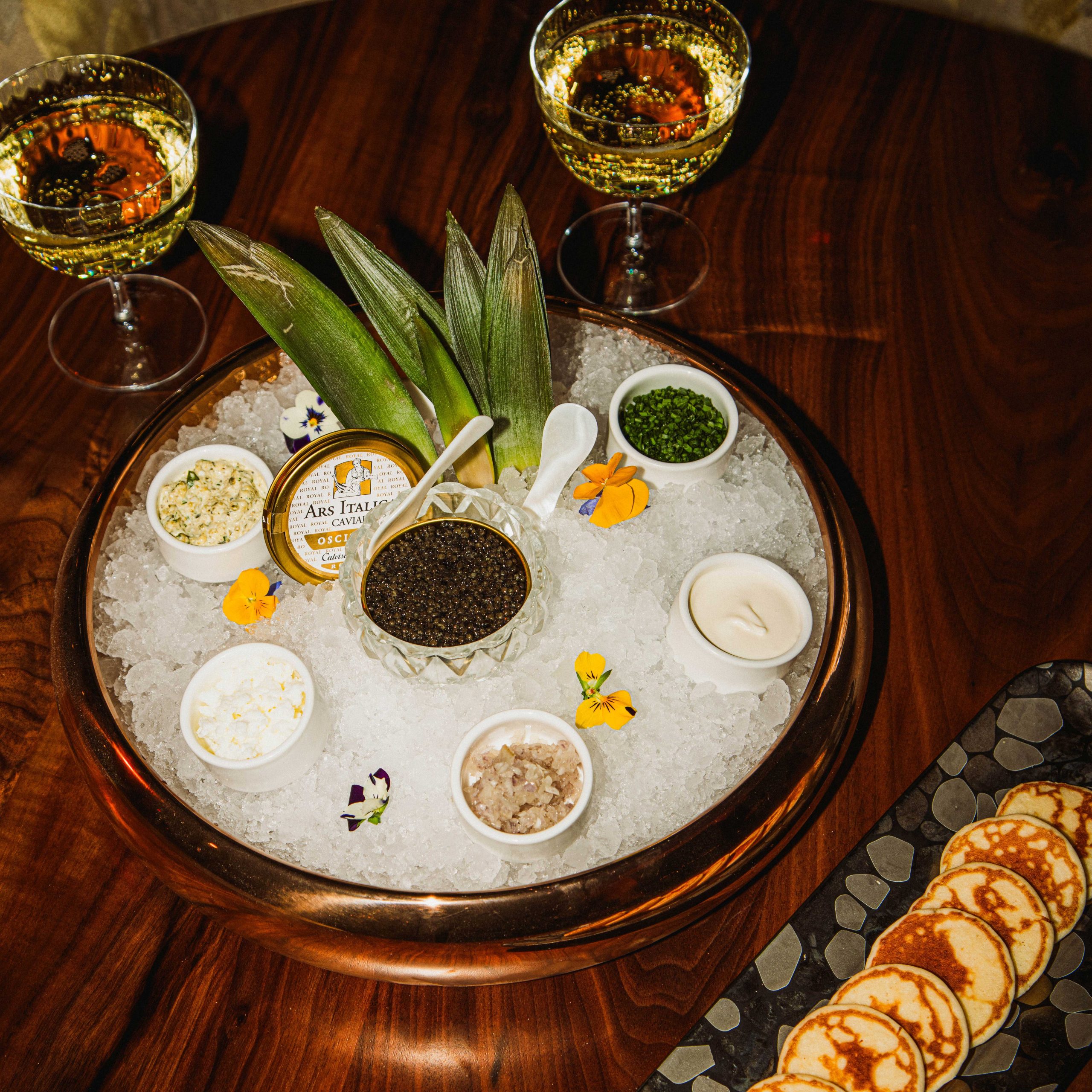 Caviar Royal Ostera with warm blinis, creme fraiche, shallots, chives and chopped egg